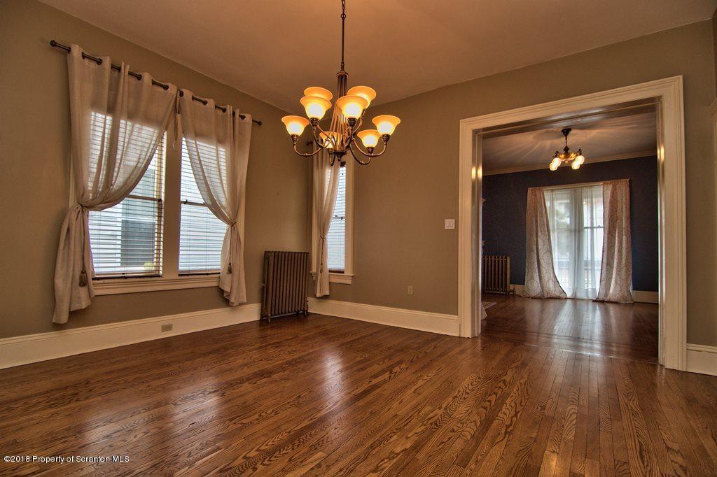 754 Green Ridge Street Scranton, PA 18509 - Photo 35 of 77 a view of an empty room with wooden floor and a window