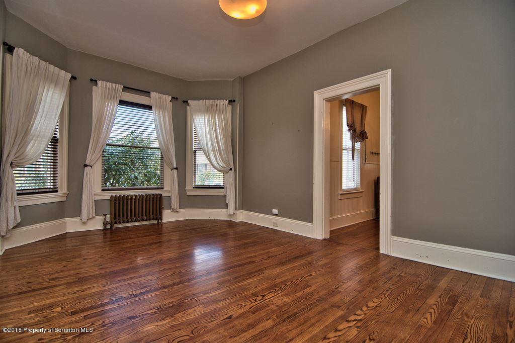 754 Green Ridge Street Scranton, PA 18509 - Photo 37 of 77 an empty room with wooden floor and windows