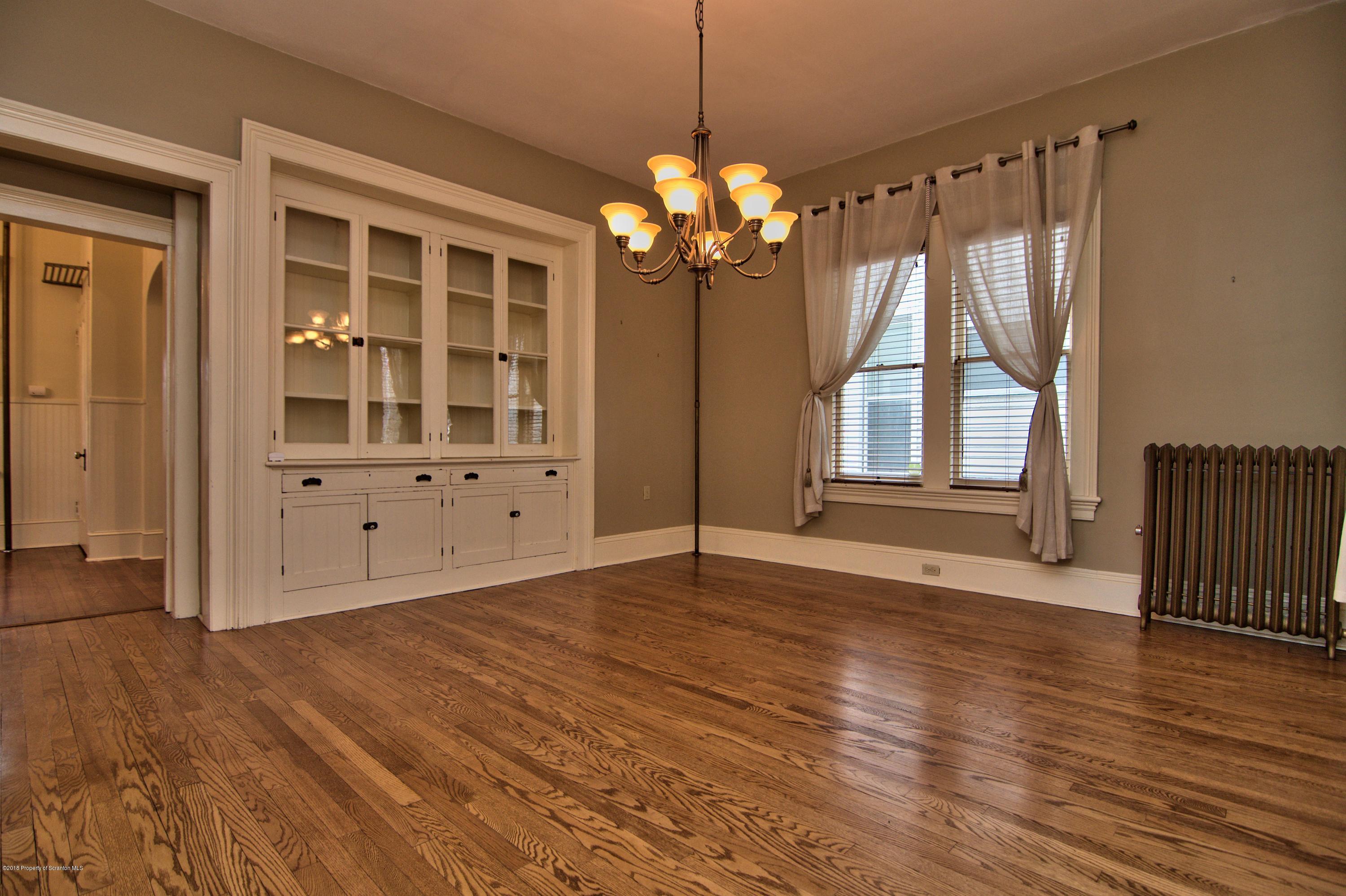 754 Green Ridge Street Scranton, PA 18509 - Photo 4 of 77 a view of an empty room with wooden floor and a window