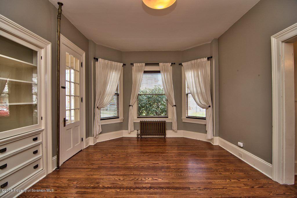 754 Green Ridge Street Scranton, PA 18509 - Photo 41 of 77 a view of an empty room with wooden floor and a window