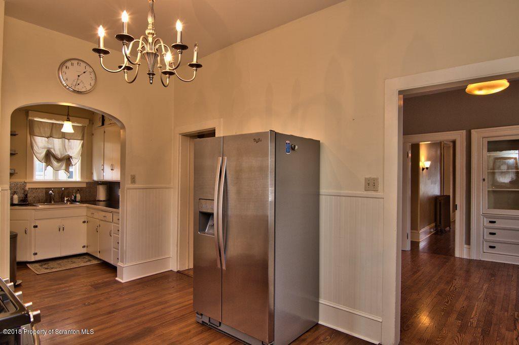 754 Green Ridge Street Scranton, PA 18509 - Photo 46 of 77 a view of a kitchen with a refrigerator and wooden floor