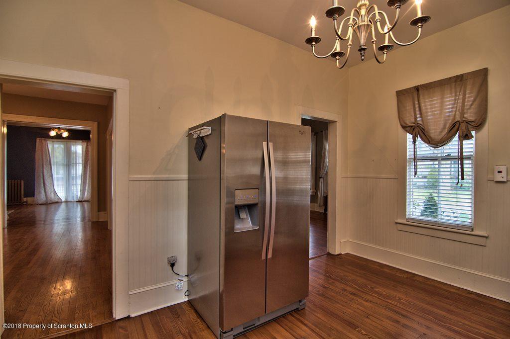 754 Green Ridge Street Scranton, PA 18509 - Photo 49 of 77 a view of a livingroom with wooden floor and chandelier