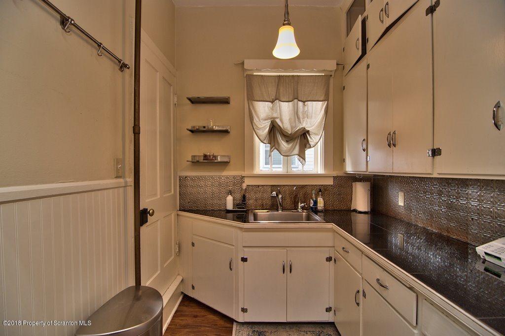 754 Green Ridge Street Scranton, PA 18509 - Photo 50 of 77 a kitchen with a sink and cabinets