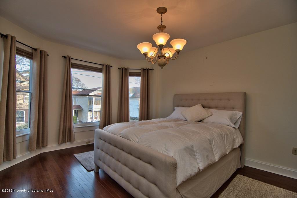 754 Green Ridge Street Scranton, PA 18509 - Photo 55 of 77 a spacious bedroom with a bed and a large window