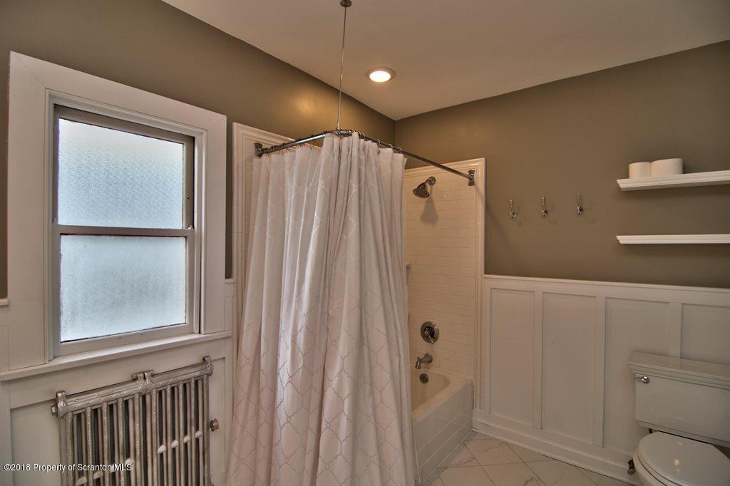 754 Green Ridge Street Scranton, PA 18509 - Photo 59 of 77 a bathroom with a shower and a window