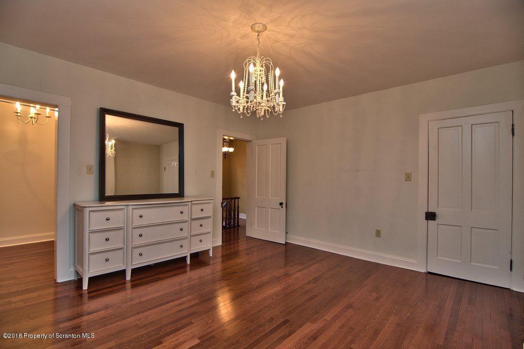 754 Green Ridge Street Scranton, PA 18509 - Photo 63 of 77 an empty room with wooden floor cabinet and windows