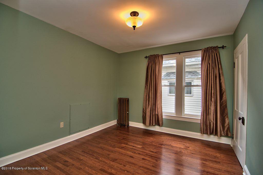 754 Green Ridge Street Scranton, PA 18509 - Photo 64 of 77 a view of an empty room with wooden floor and a window