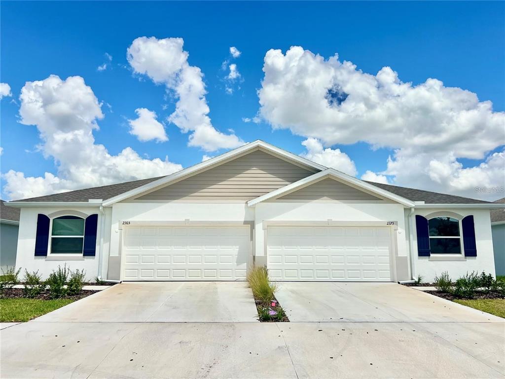 2373 Bending Bonsai Drive Wesley Chapel, FL 33543 - Photo 1 of 29 a front view of a house with a yard and a garage