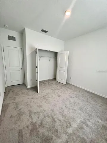 an empty room with closet and cabinet