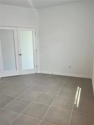 a view of a room with an empty space and window