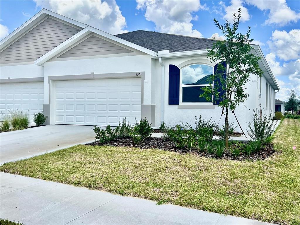 2373 Bending Bonsai Drive Wesley Chapel, FL 33543 - Photo 2 of 29 a front view of a house with garden