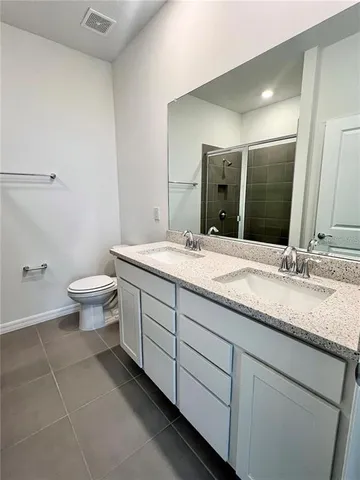 a bathroom with a double vanity sink and a mirror