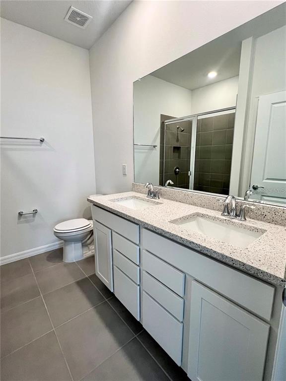 2373 Bending Bonsai Drive Wesley Chapel, FL 33543 - Photo 22 of 29 a bathroom with a double vanity sink and a mirror