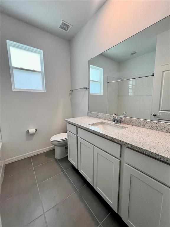 2373 Bending Bonsai Drive Wesley Chapel, FL 33543 - Photo 24 of 29 a bathroom with a double vanity sink and a toilet