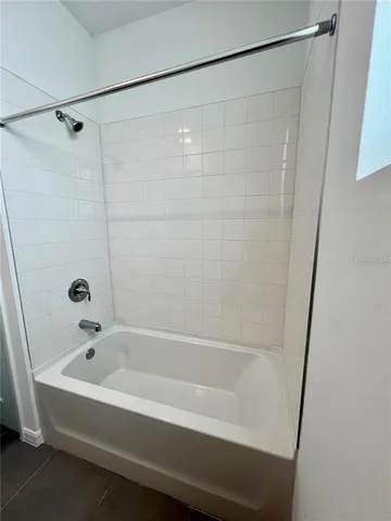 a bathroom with a bathtub and shower