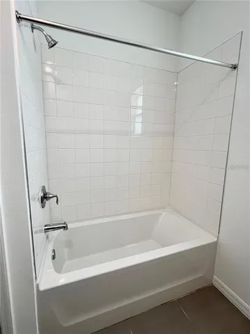 a bathroom with a shower and a bath tub