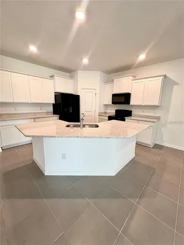 a kitchen with stainless steel appliances a refrigerator sink microwave and cabinets