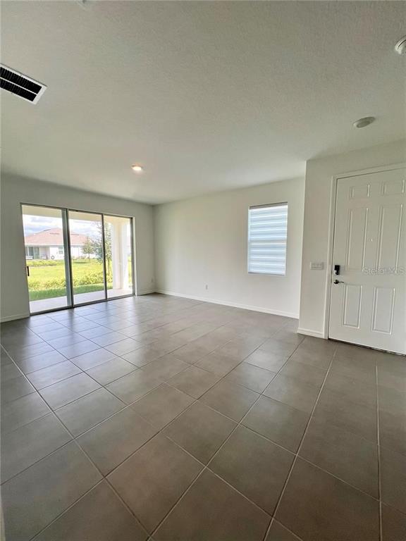 2373 Bending Bonsai Drive Wesley Chapel, FL 33543 - Photo 7 of 29 a view of an empty room with a window