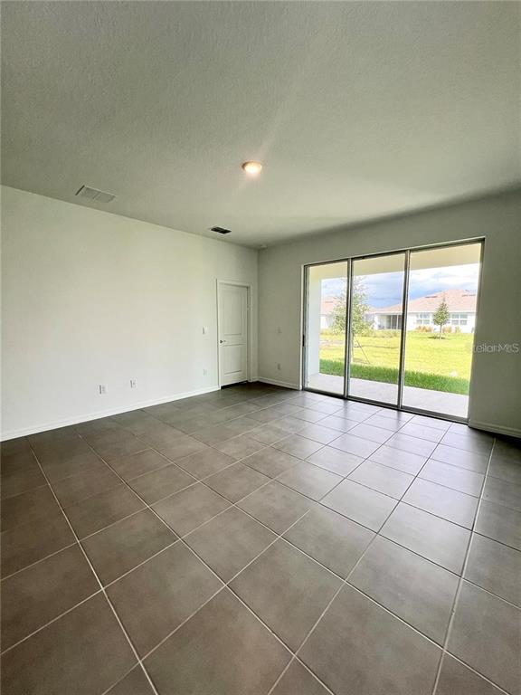 2373 Bending Bonsai Drive Wesley Chapel, FL 33543 - Photo 9 of 29 a view of an empty room with a window