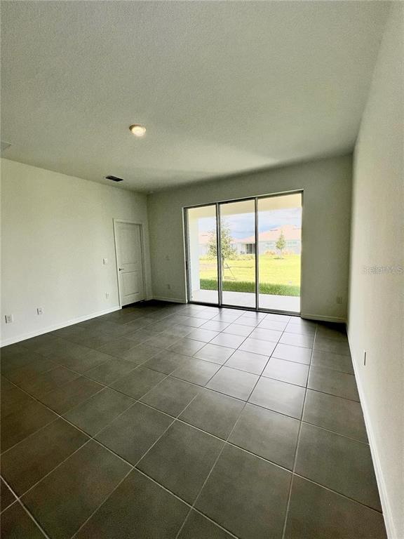 2373 Bending Bonsai Drive Wesley Chapel, FL 33543 - Photo 10 of 29 a view of an empty room with a window