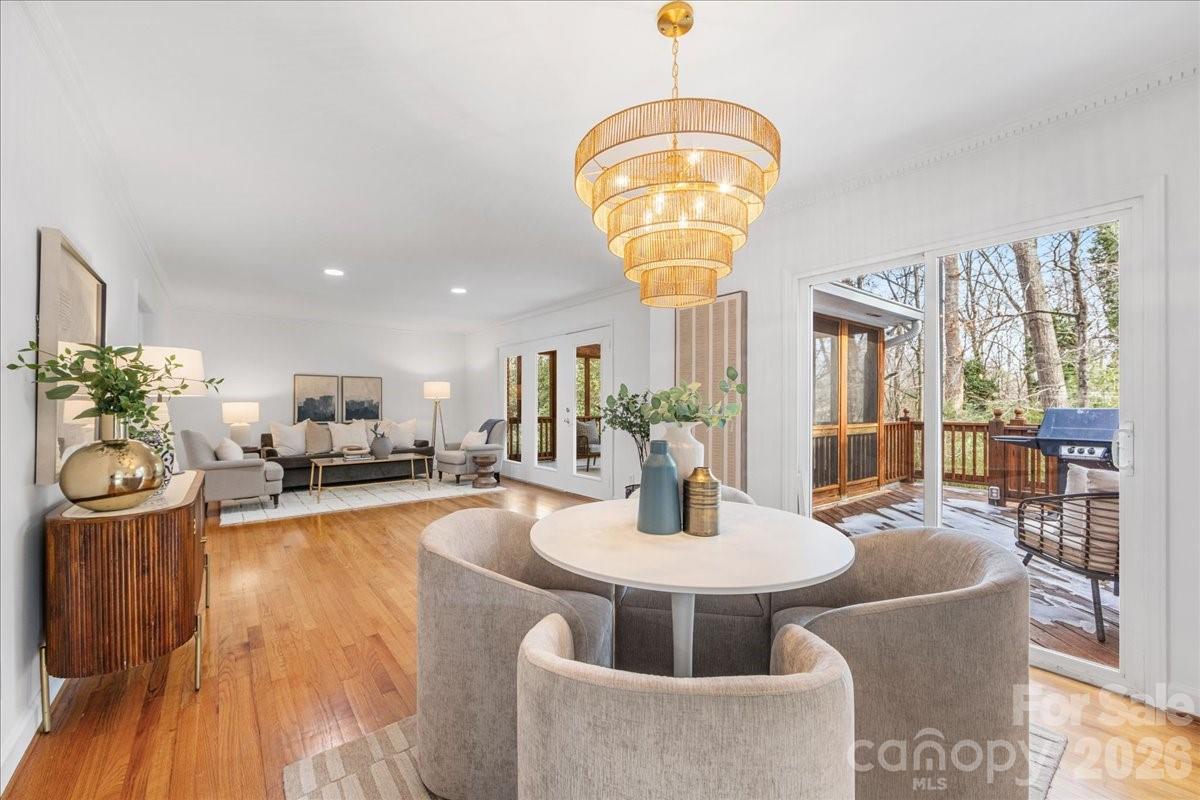 7201 Terrace Drive Charlotte, NC 28211 - Photo 15 of 48 a view of a dining room with furniture a chandelier and wooden floor