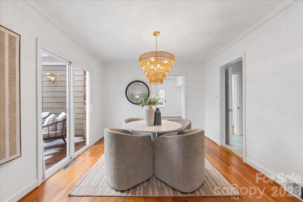 7201 Terrace Drive Charlotte, NC 28211 - Photo 16 of 48 a living room with wooden floor and a chandelier
