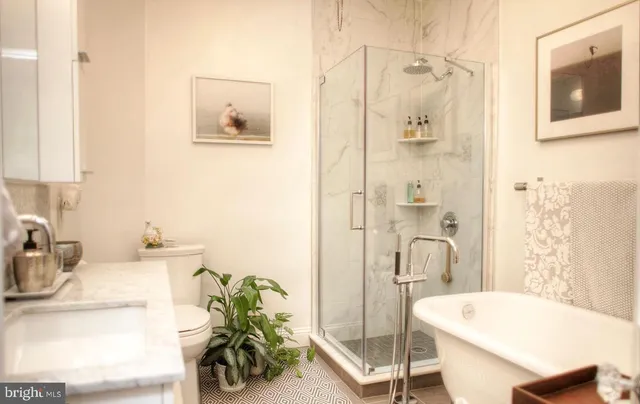 a bathroom with a tub sink and mirror