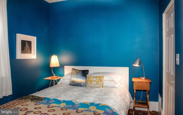 a bedroom with a bed and a lamp on table