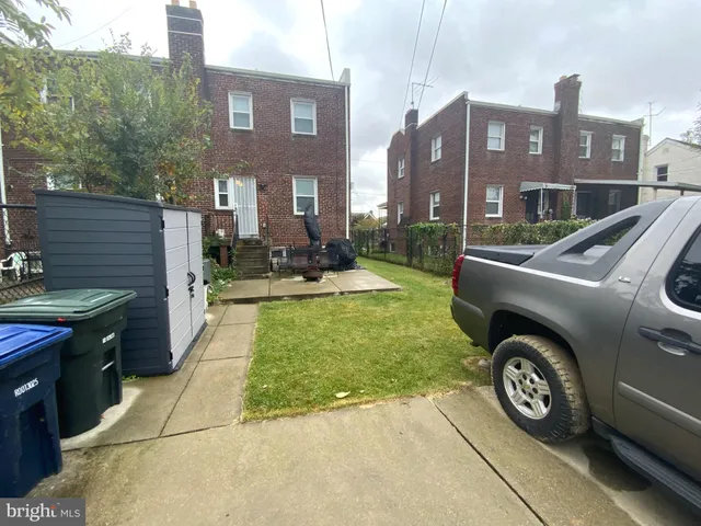 a view of a car parked in front of a brick house
