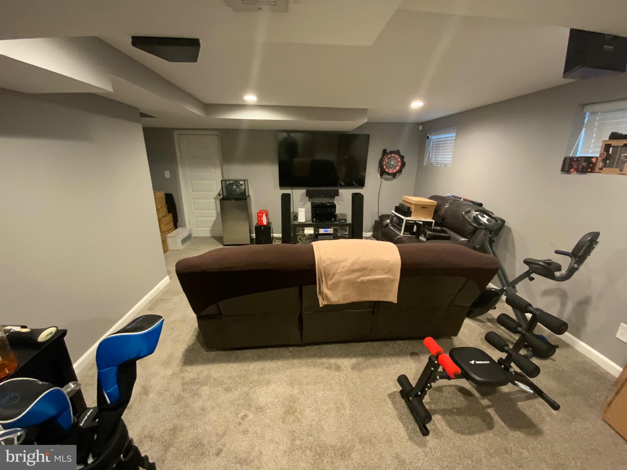 540 Lebaum Street Southeast Washington, DC 20032 - Photo 19 of 25 a living room with furniture a flat screen tv and a mirror