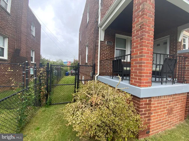 a view of a brick house with a large windows