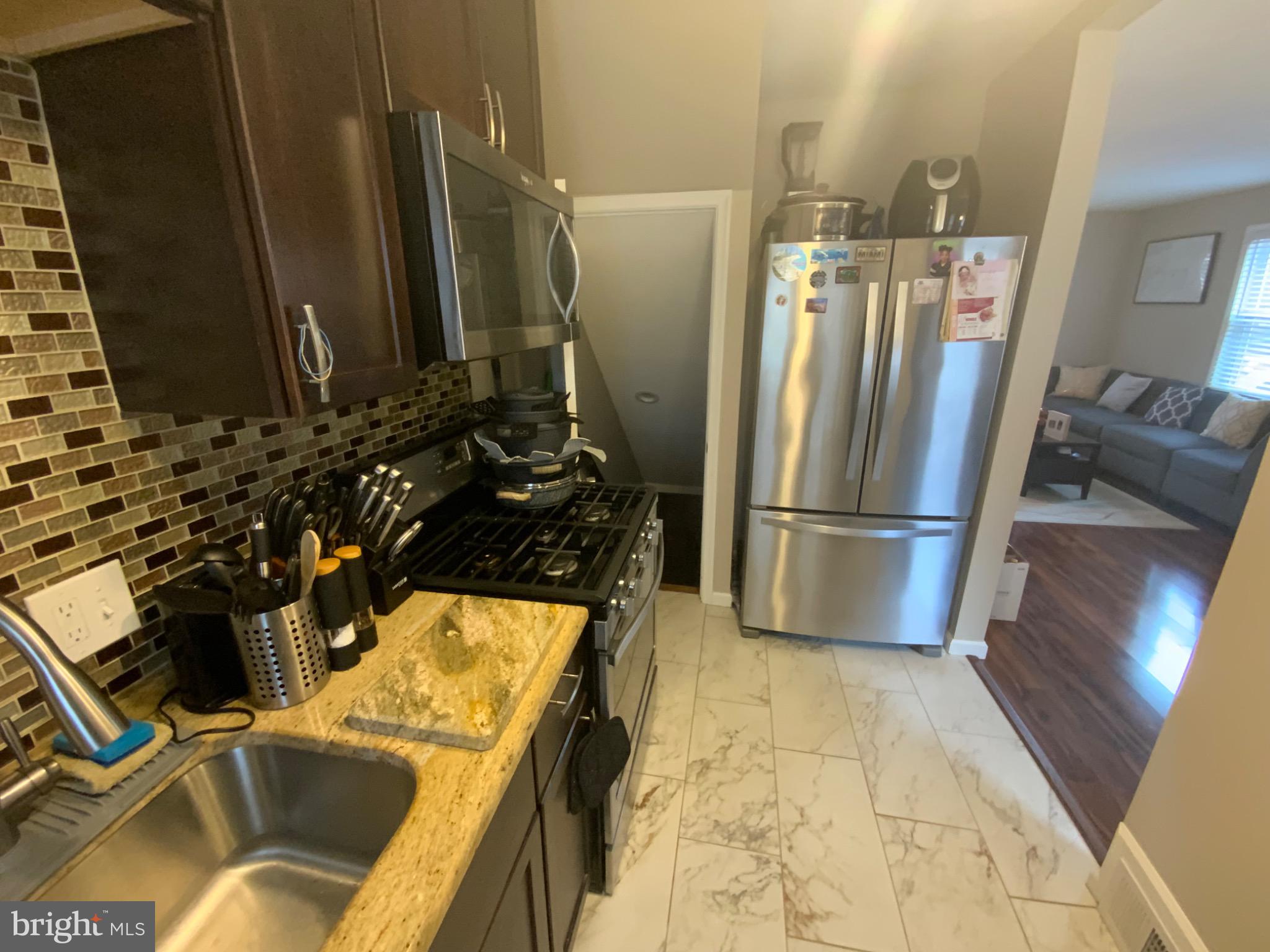 540 Lebaum Street Southeast Washington, DC 20032 - Photo 8 of 25 a kitchen with a refrigerator and a sink