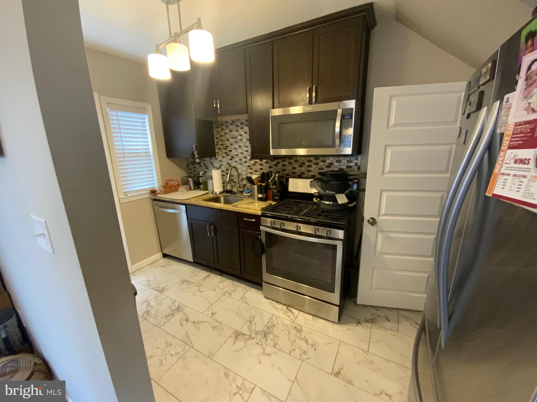 540 Lebaum Street Southeast Washington, DC 20032 - Photo 9 of 25 a bathroom with a sink a large mirror and a shower