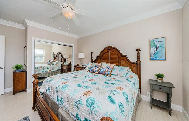 a bedroom with bed and a chandelier