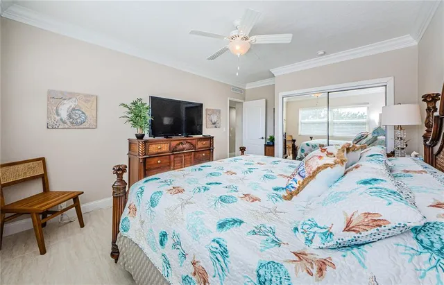 a bed room with a bed a television and a couch