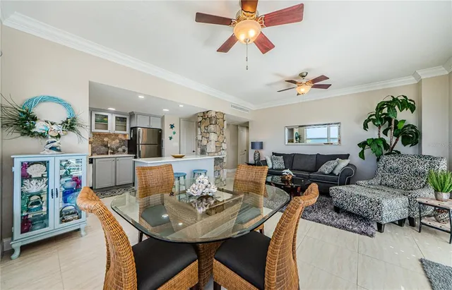 a living room with furniture kitchen and a chandelier