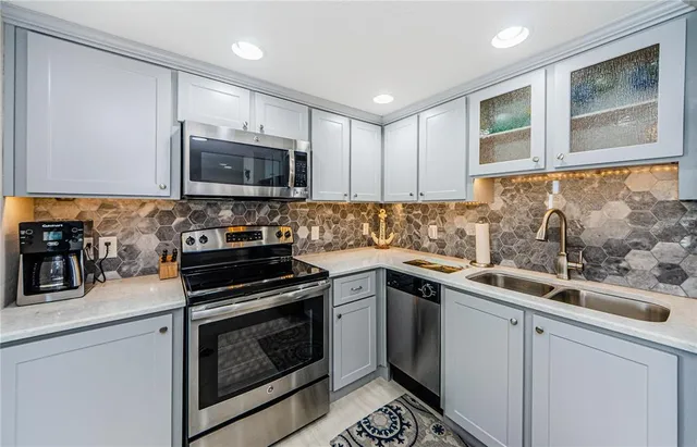 a kitchen with a sink stove and microwave