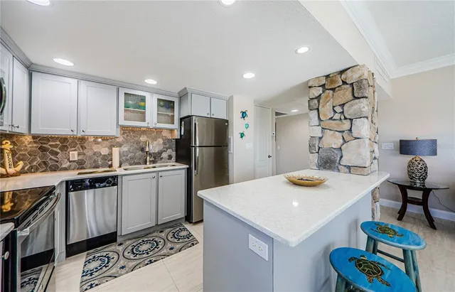a kitchen that has a sink and a refrigerator in it