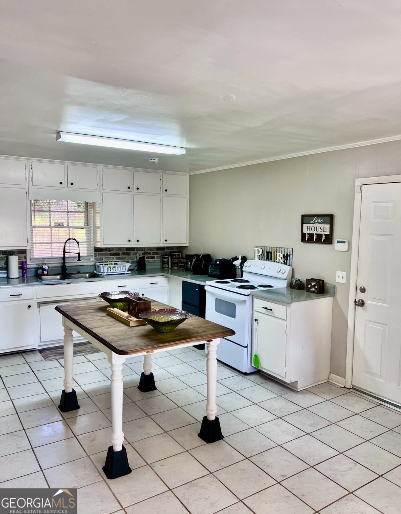 1286 Oak Hill Road Covington, GA 30016 - Photo 6 of 10 a kitchen with a sink a stove cabinets and counter space