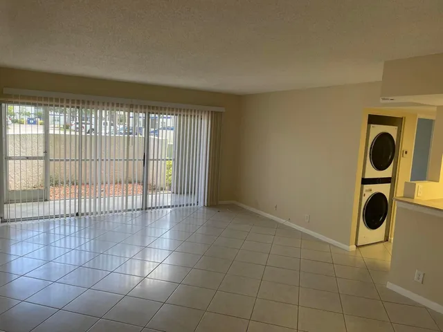a view of an empty room and glass door