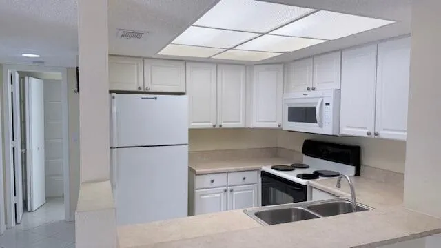 a kitchen with stainless steel appliances granite countertop a refrigerator sink and stove