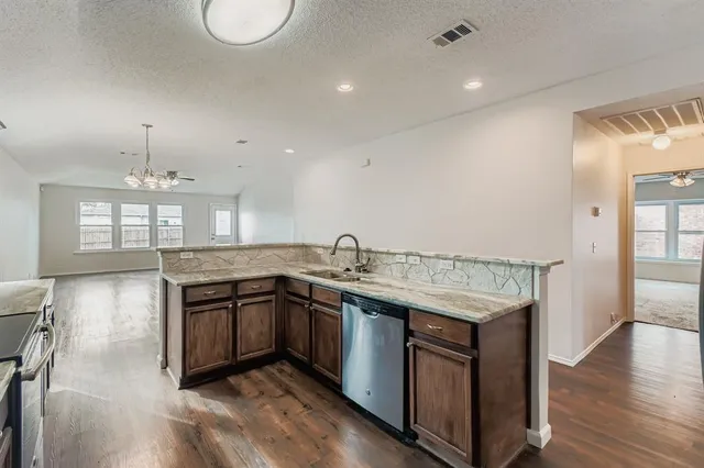 a kitchen with stainless steel appliances granite countertop a sink and stove