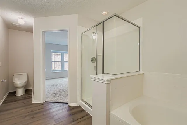 a bathroom with a shower a toilet and a sink