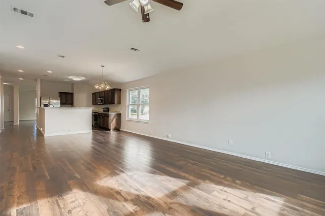a view of kitchen and hall with wooden floor