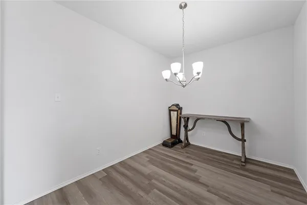 a view of a room with a wooden floor and a ceiling fan