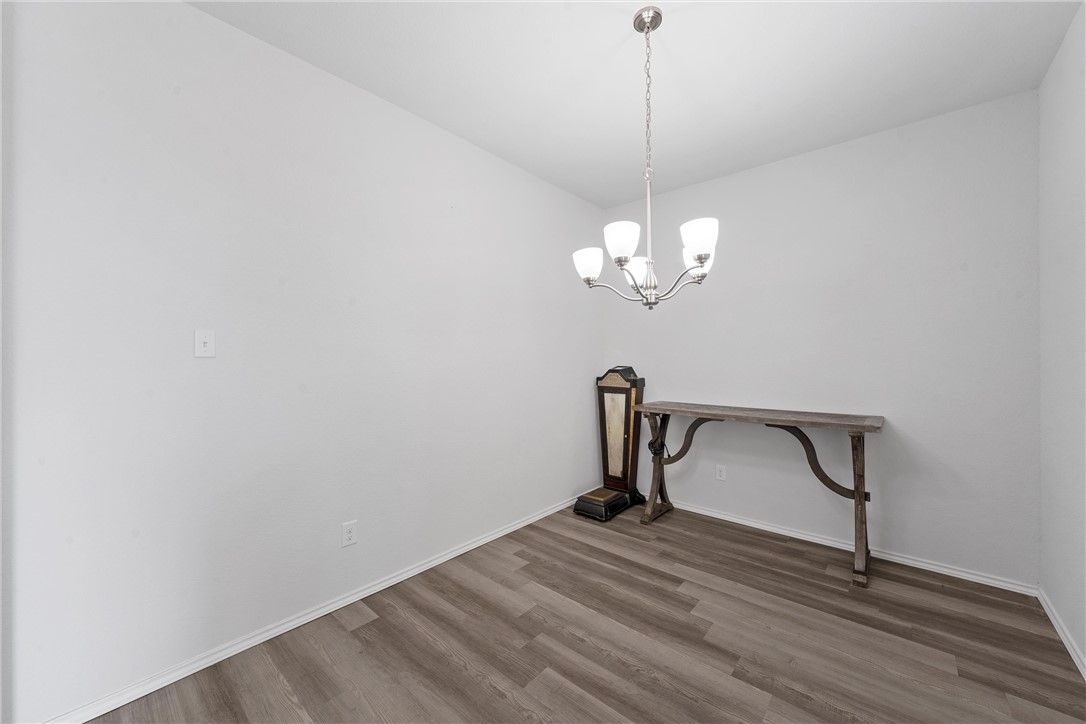 11208 Echo Drive Waco, TX 76708 - Photo 13 of 34 a view of a room with a wooden floor and a ceiling fan