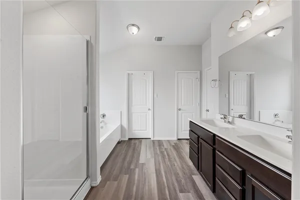 a bathroom with a double vanity sink and a mirror