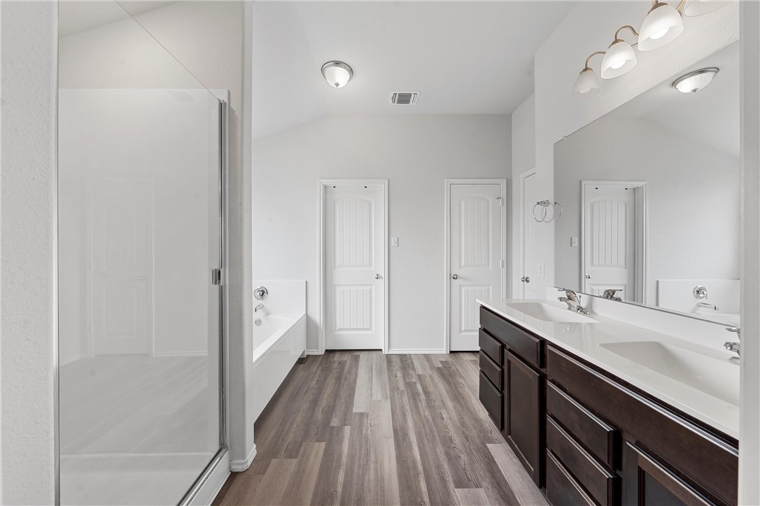 11208 Echo Drive Waco, TX 76708 - Photo 19 of 34 a spacious bathroom with a double vanity sink and a mirror