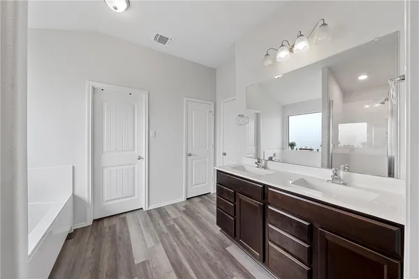 a bathroom with a bathtub and a shower