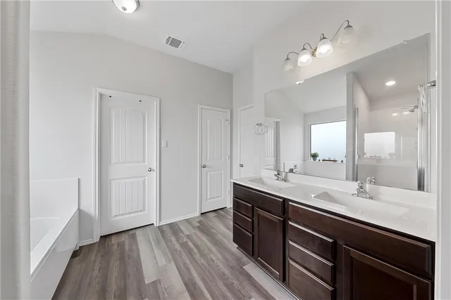 a bathroom with a bathtub and a shower